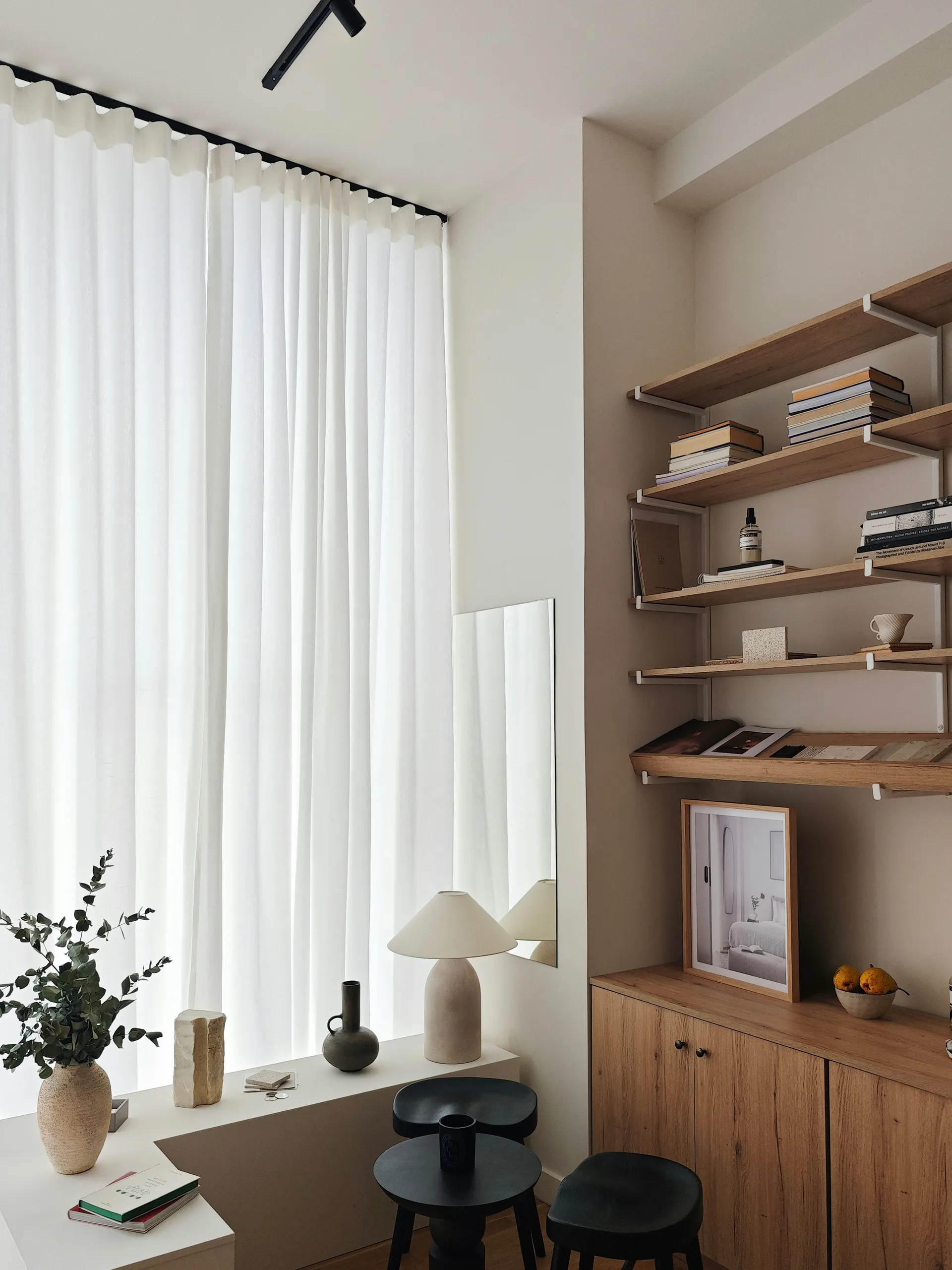 Fineline Studio’s material library and meeting area beside a softly curtained window