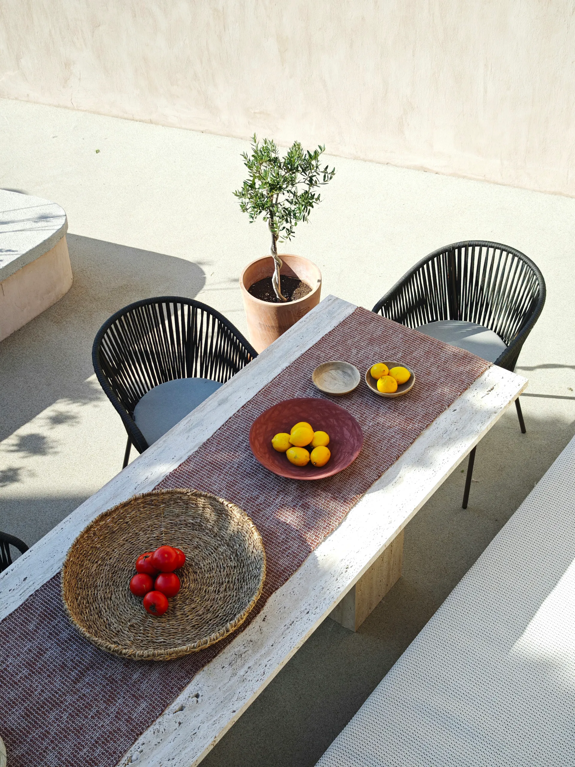 Rectangular travertine dining table set for an outdoor meal